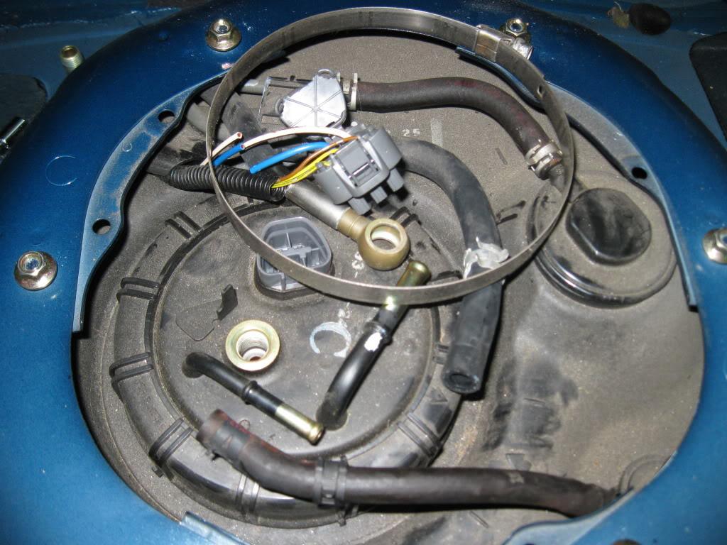 disconnecting hoses and plugs to top of fuel sending unit
