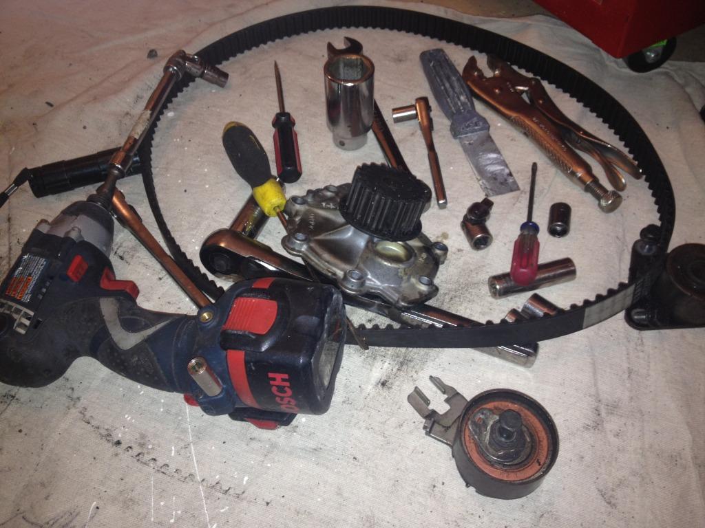 Tools and water pump, timing belt idler pulley, timing belt tensioner, and 2 accessories belts
