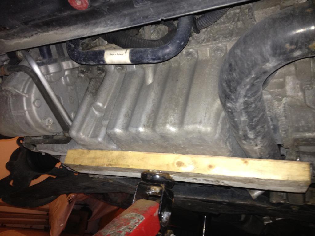 jack and a foot long piece of 2x4 under oil pan