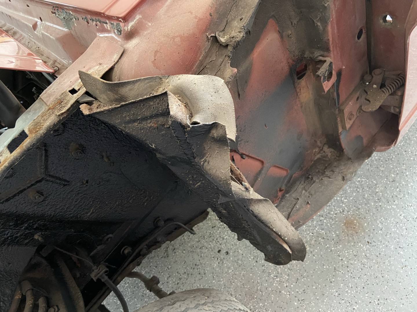 The left front fender had been replaced, but the shop didn't bother to even straighten out the inner fender shield, let alone replace it as they should have.